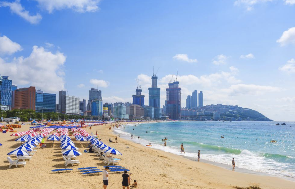 Haeundae Beach in Busan during summer with umbrellas and tourists, highlighting the best time to visit Korea for beaches