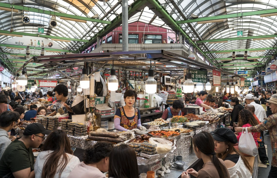 Seoul food markets at Gwangjang Market with Korean street food stalls serving bindaetteok and gimbap