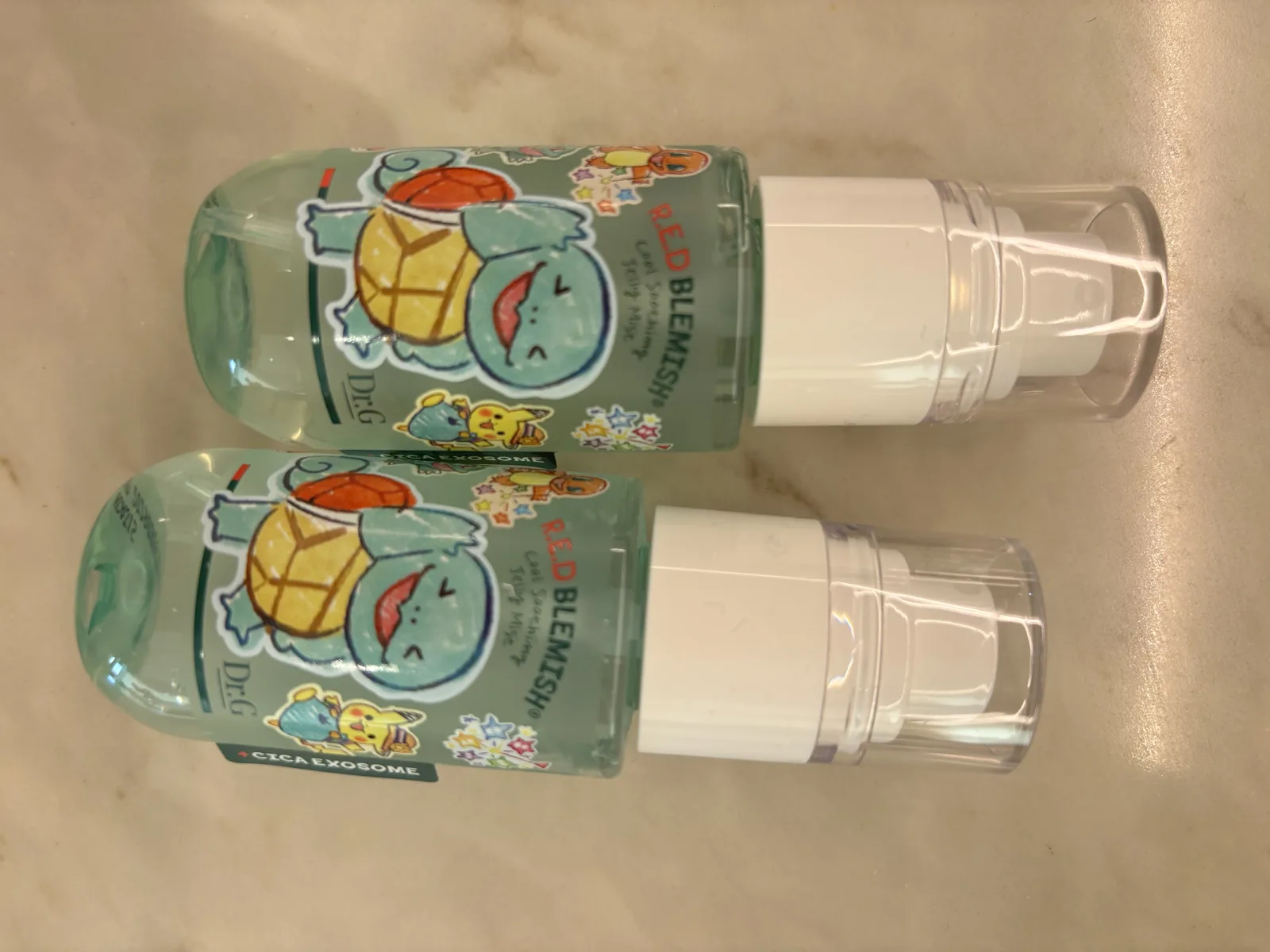Dr.G Red Blemish Serum two clear pump bottles with mint formula and Pokémon collab packaging