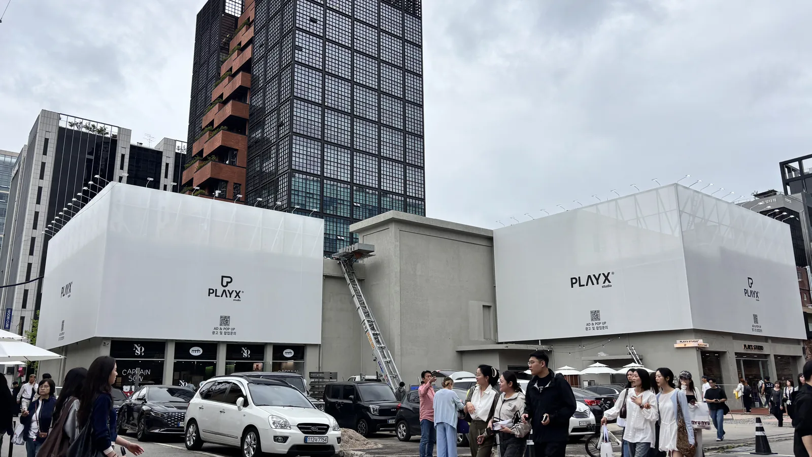 Seongsu industrial architecture landmark — the black steel-mesh tower over the PLAYX plaza