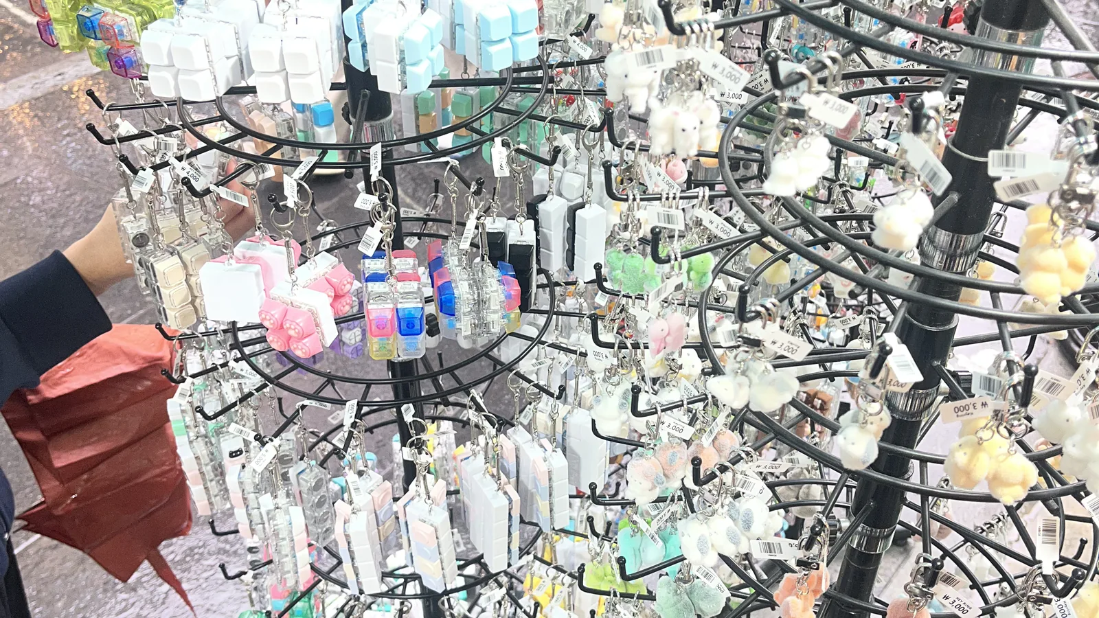 What to buy in Myeongdong — a souvenir and keychain stand on a Myeongdong street