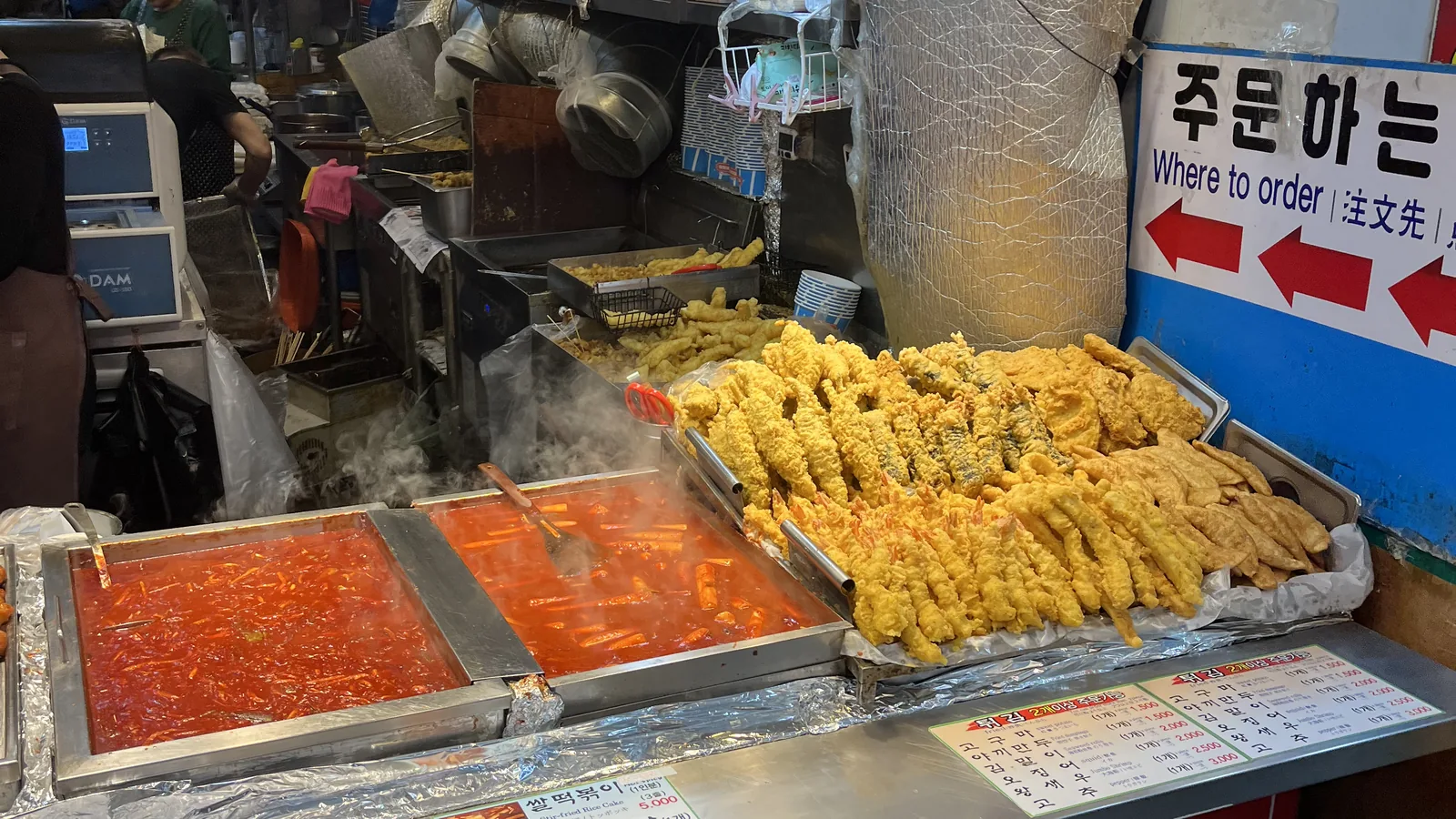 Namdaemun Market street food shown by a tteokbokki and fried snack stall