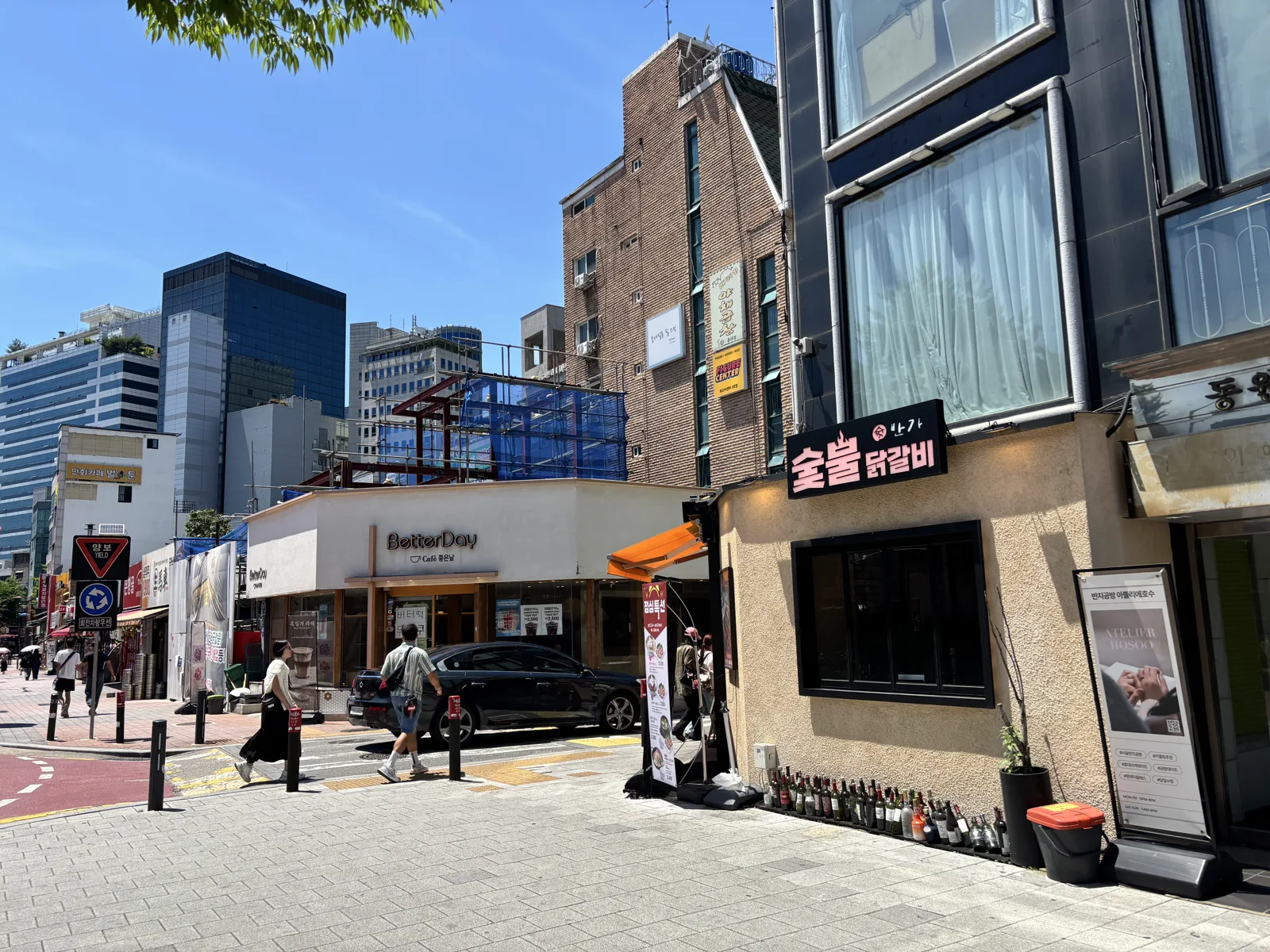 Storefronts and side-street shops along the Hongdae shopping street in Seoul
