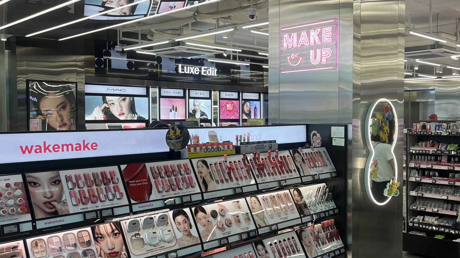 Olive Young Gangnam makeup floor with lit tester counters and mirrors