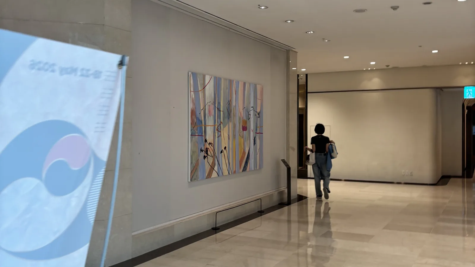 Lotte Hotel World review elegant lobby corridor with framed artwork and soft lighting