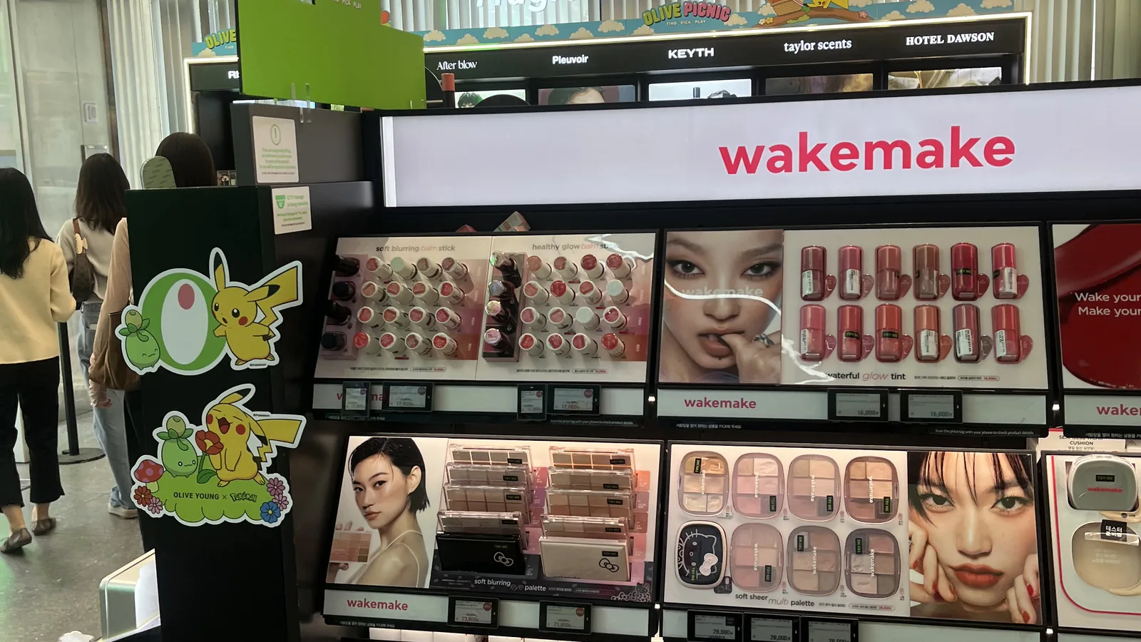 best Olive Young products on the makeup wall display inside an Olive Young store in Seoul