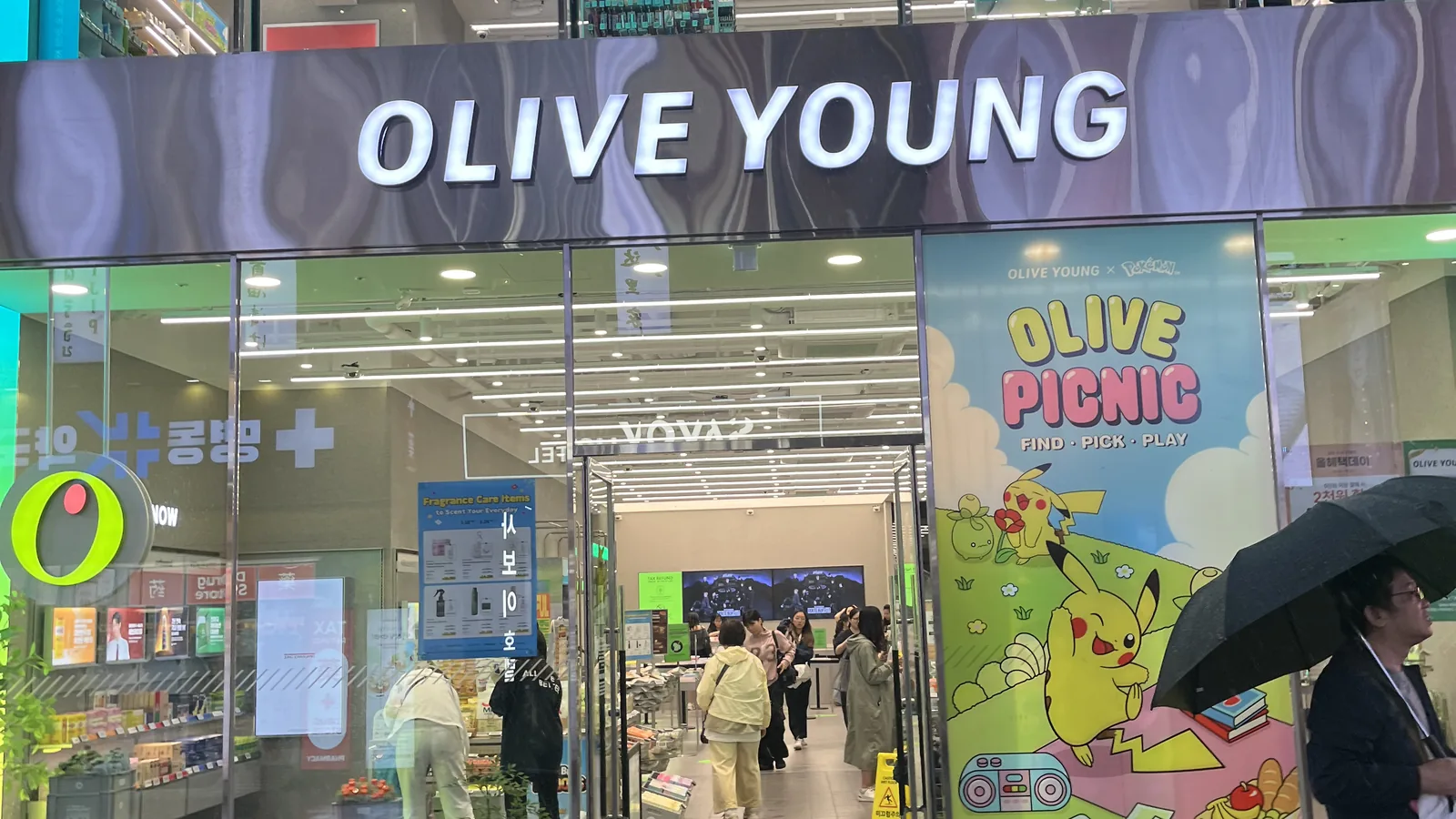 Olive Young tax refund starting point at the busy Myeongdong store entrance in Seoul