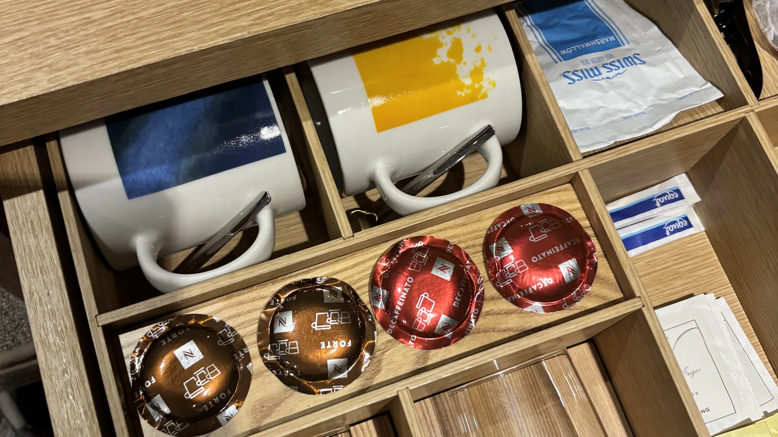 Myeongdong tourist tips for where to stay, showing a hotel room amenities drawer with mugs and tea sachets
