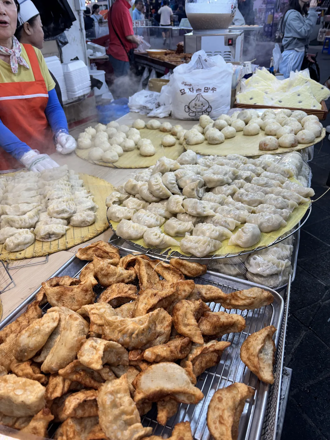 Namdaemun Market street food shown by mounds of golden fried snacks at a stall