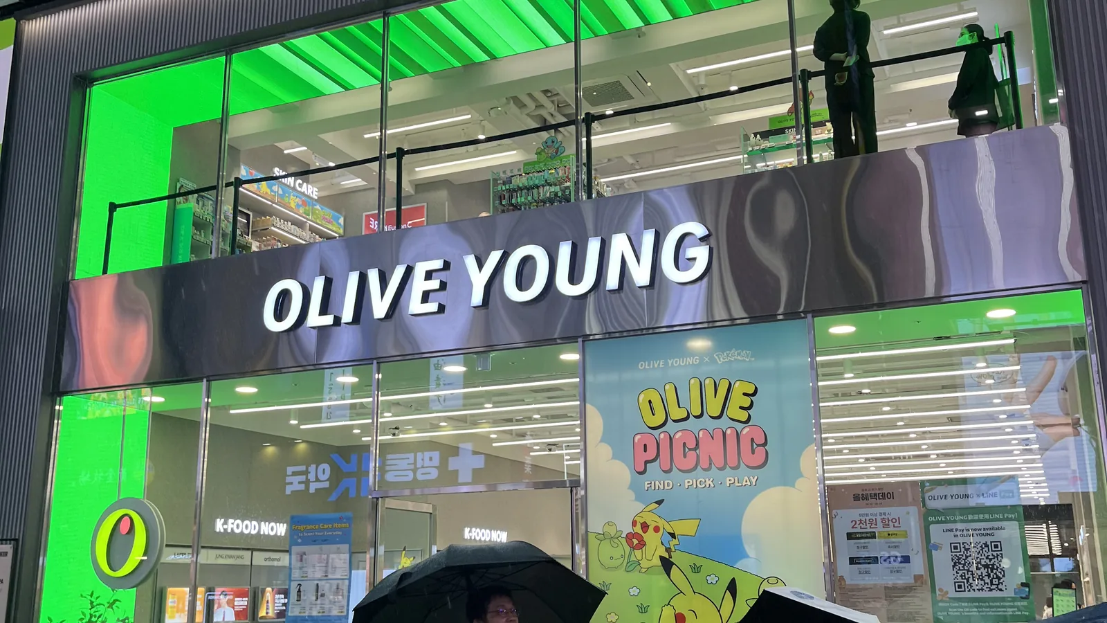 Olive Young store guide Seoul — the Myeongdong flagship storefront on a rainy day