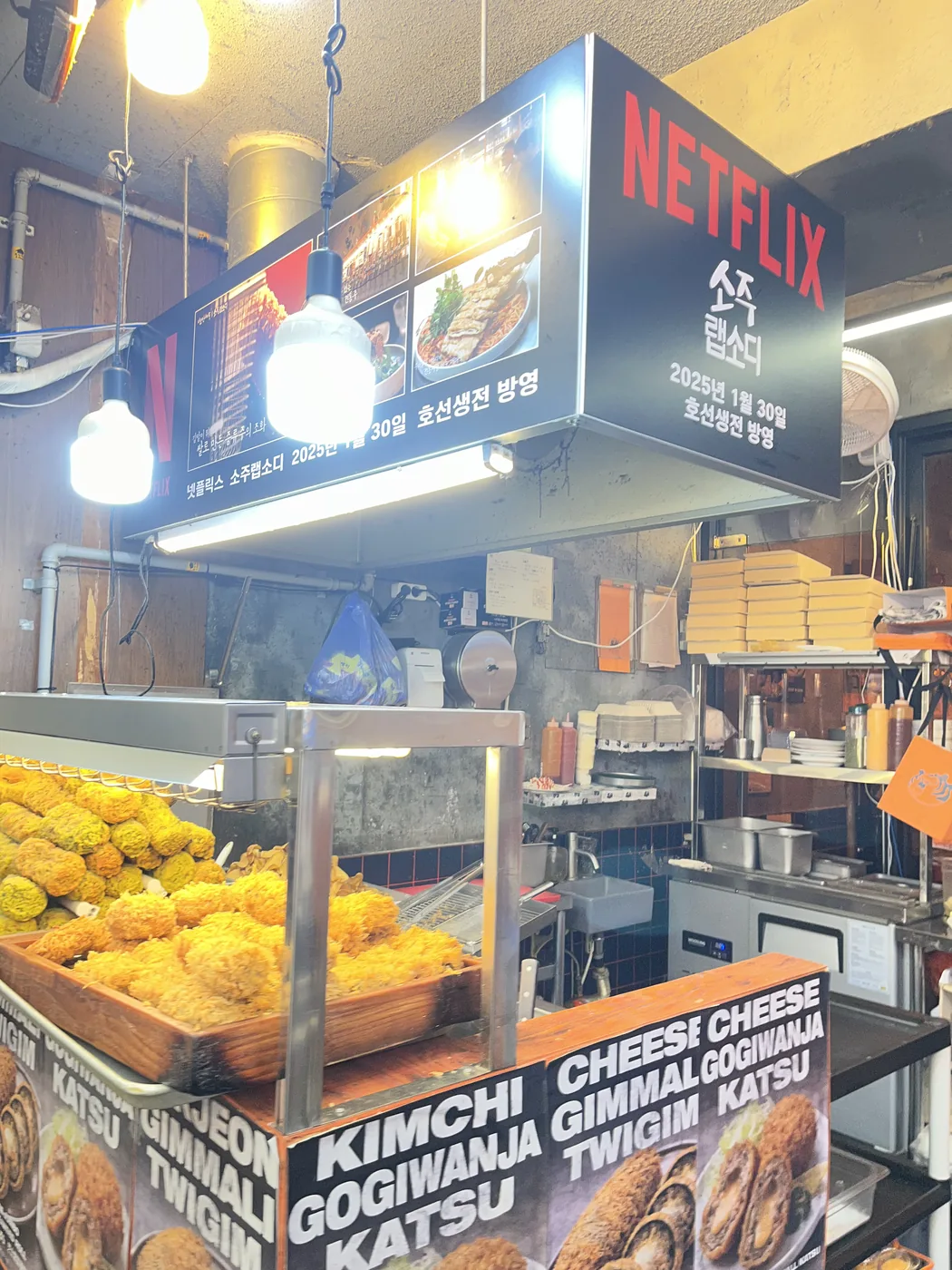 What to eat at Gwangjang Market shown by a stall piled with fried twigim snacks