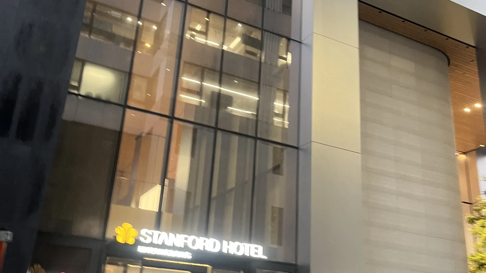 Modern glass business hotel at night showing where to stay in Myeongdong