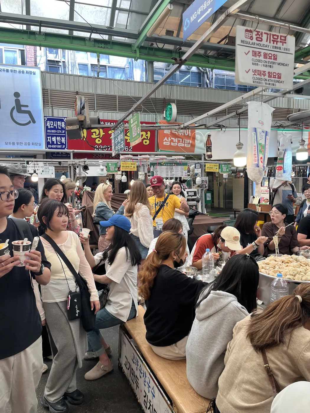 Gwangjang Market food guide view of crowds around stall seating at lunchtime