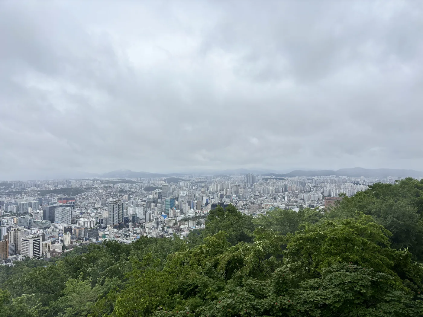N Seoul Tower observatory view of the Seoul city skyline under a low overcast sky