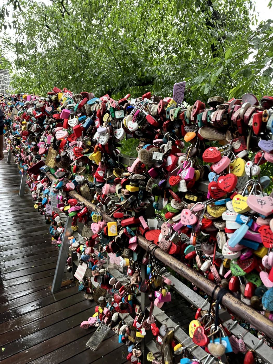 Namsan Seoul Tower guide view of the colourful love lock wall near the tower base