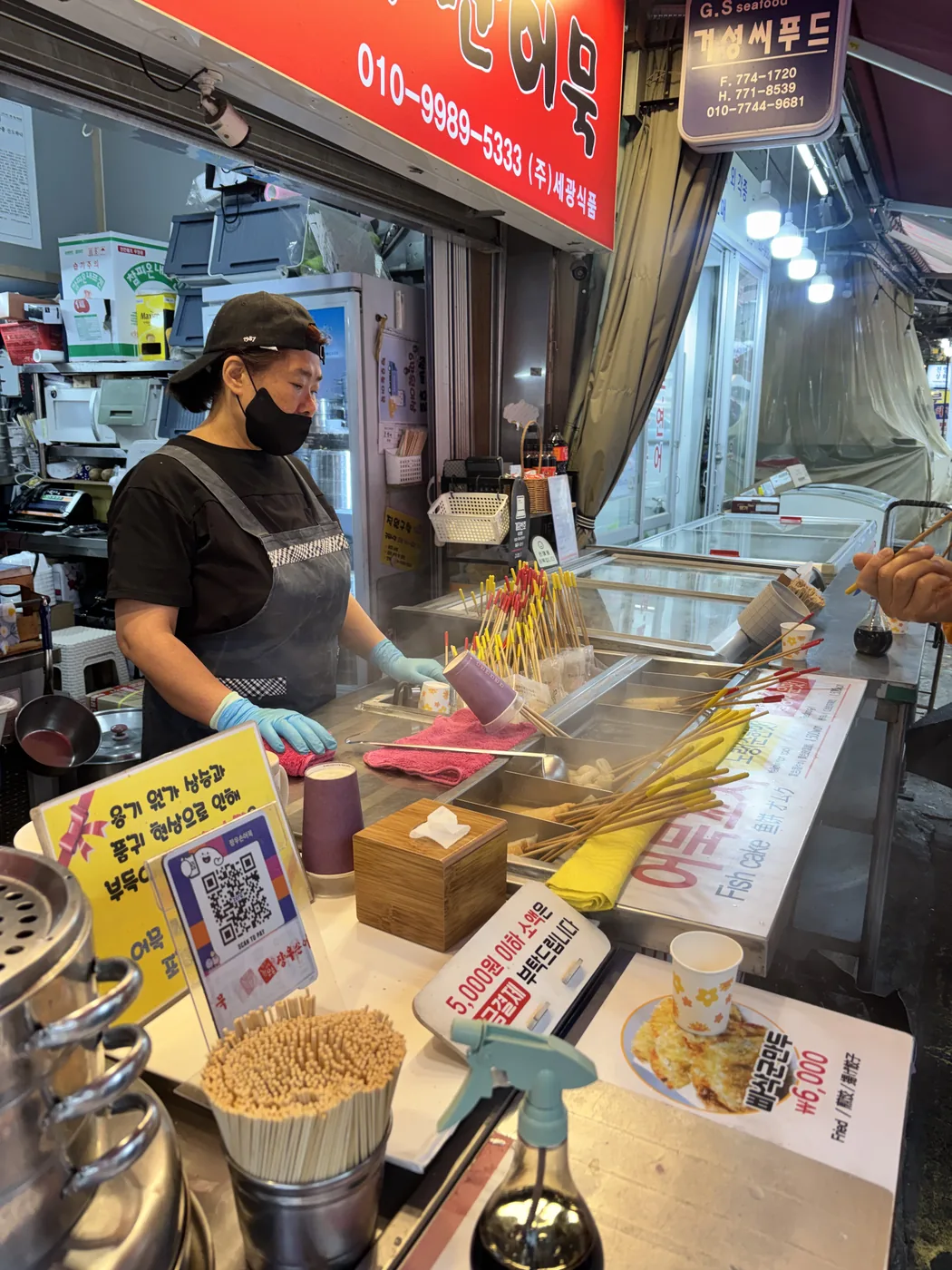 What to buy at Namdaemun Market shown by a stall stacked with snacks and packaged goods