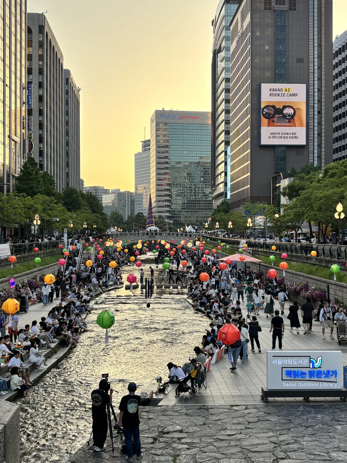 Cheonggyecheon stream walk in Seoul at sunset with crowds along the banks
