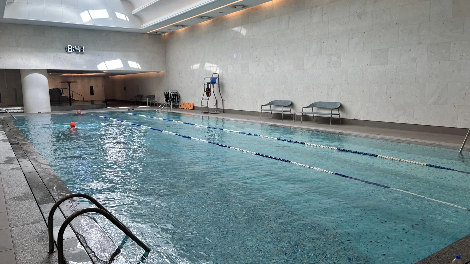 Lotte Hotel World review calm indoor swimming pool at the fitness club with sun loungers