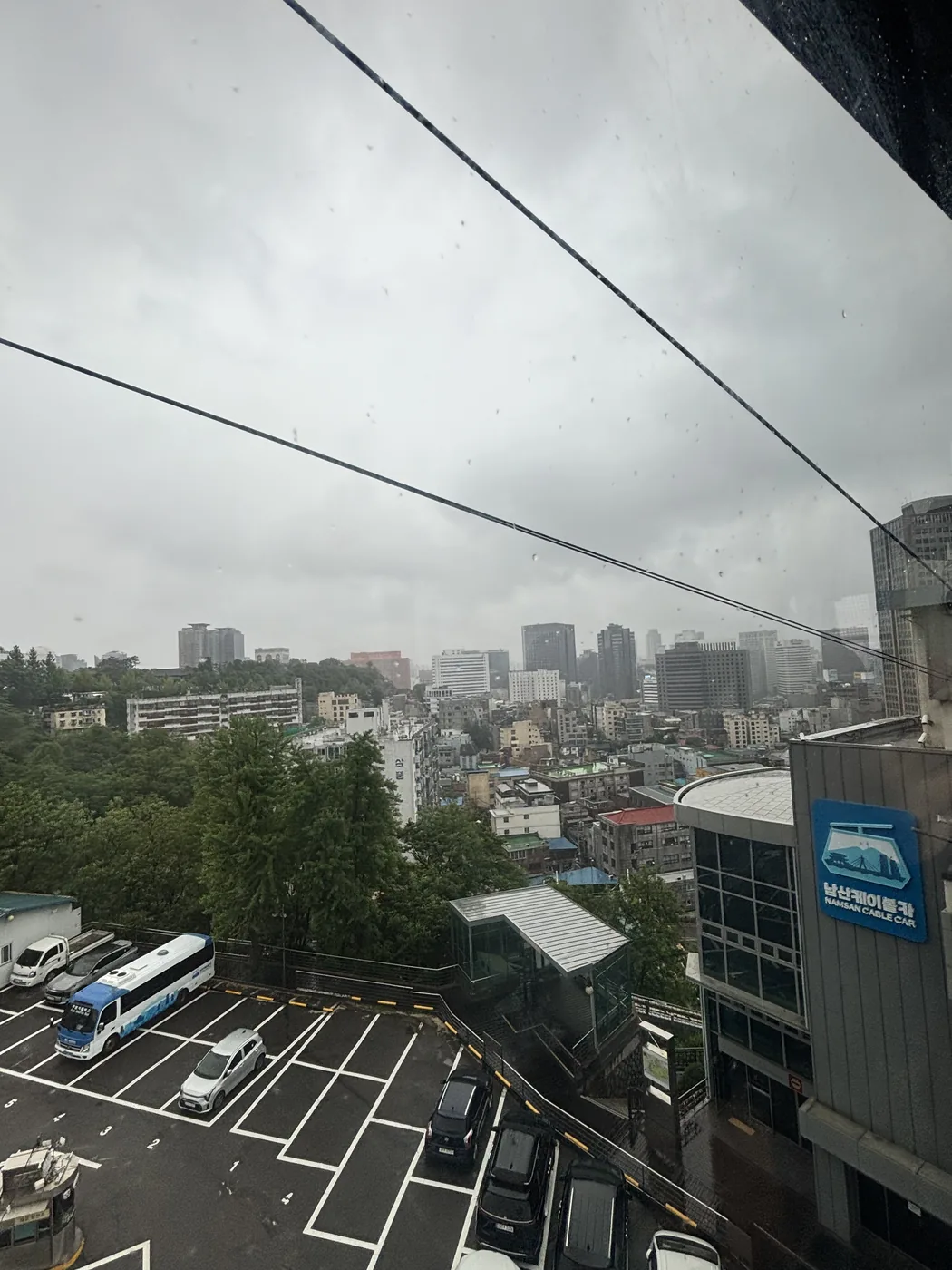 Namsan cable car guide view of the cables and foggy city seen during the ride