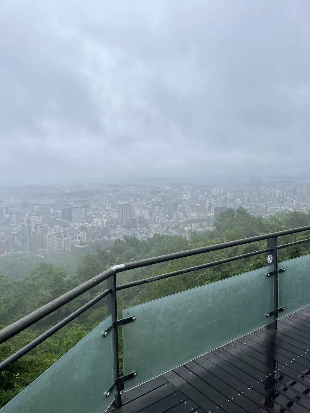 Namsan in the rain showing a foggy grey city view from the terrace