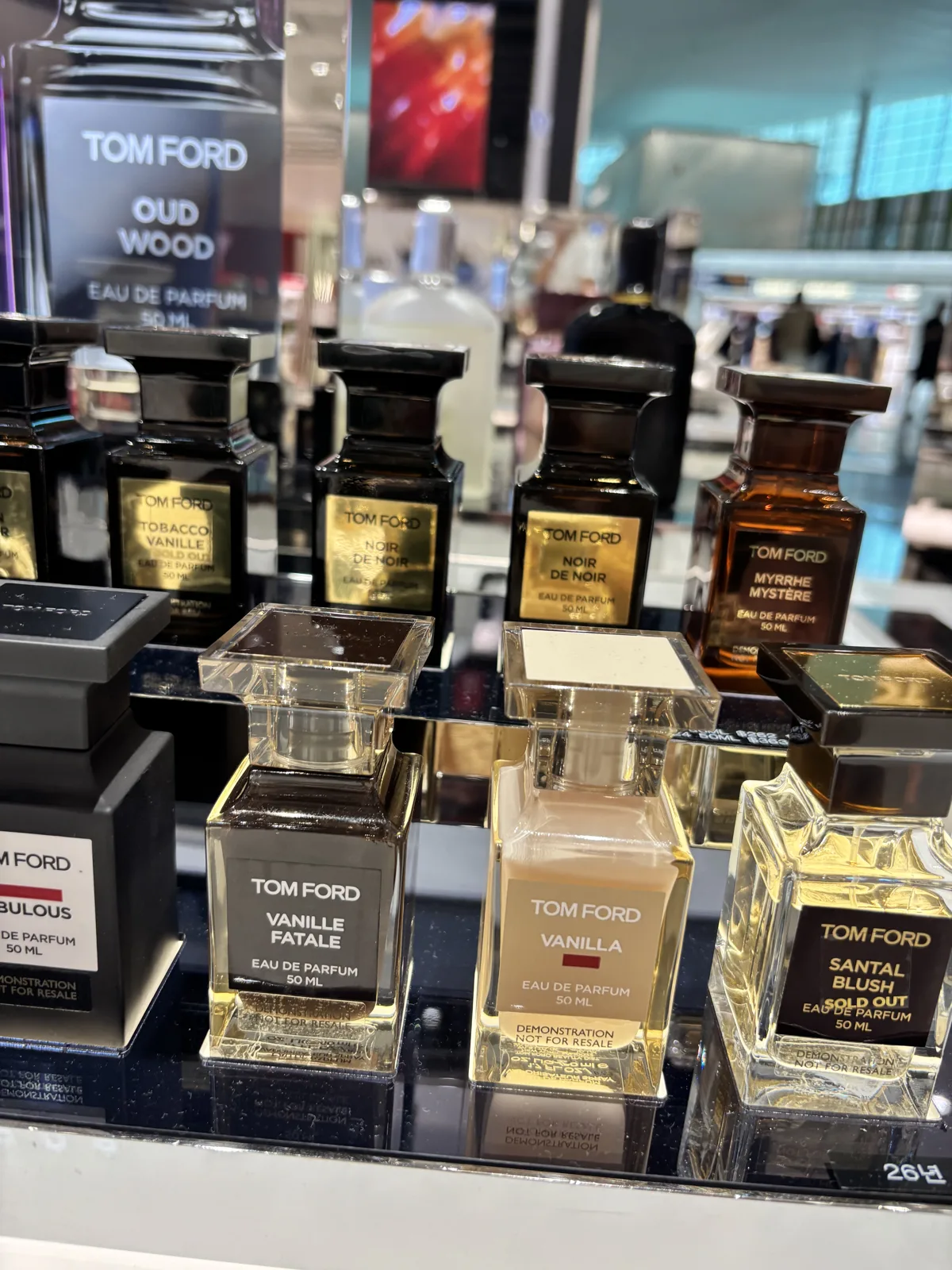 Rows of dark luxury fragrance bottles at an Incheon Airport duty-free perfume counter