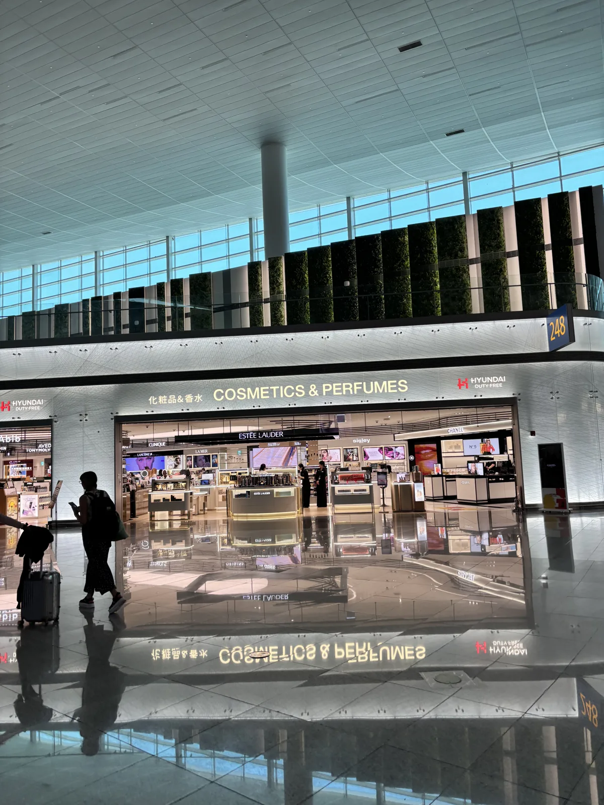 Incheon Airport duty-free hall with a Dior fragrance boutique and shoppers