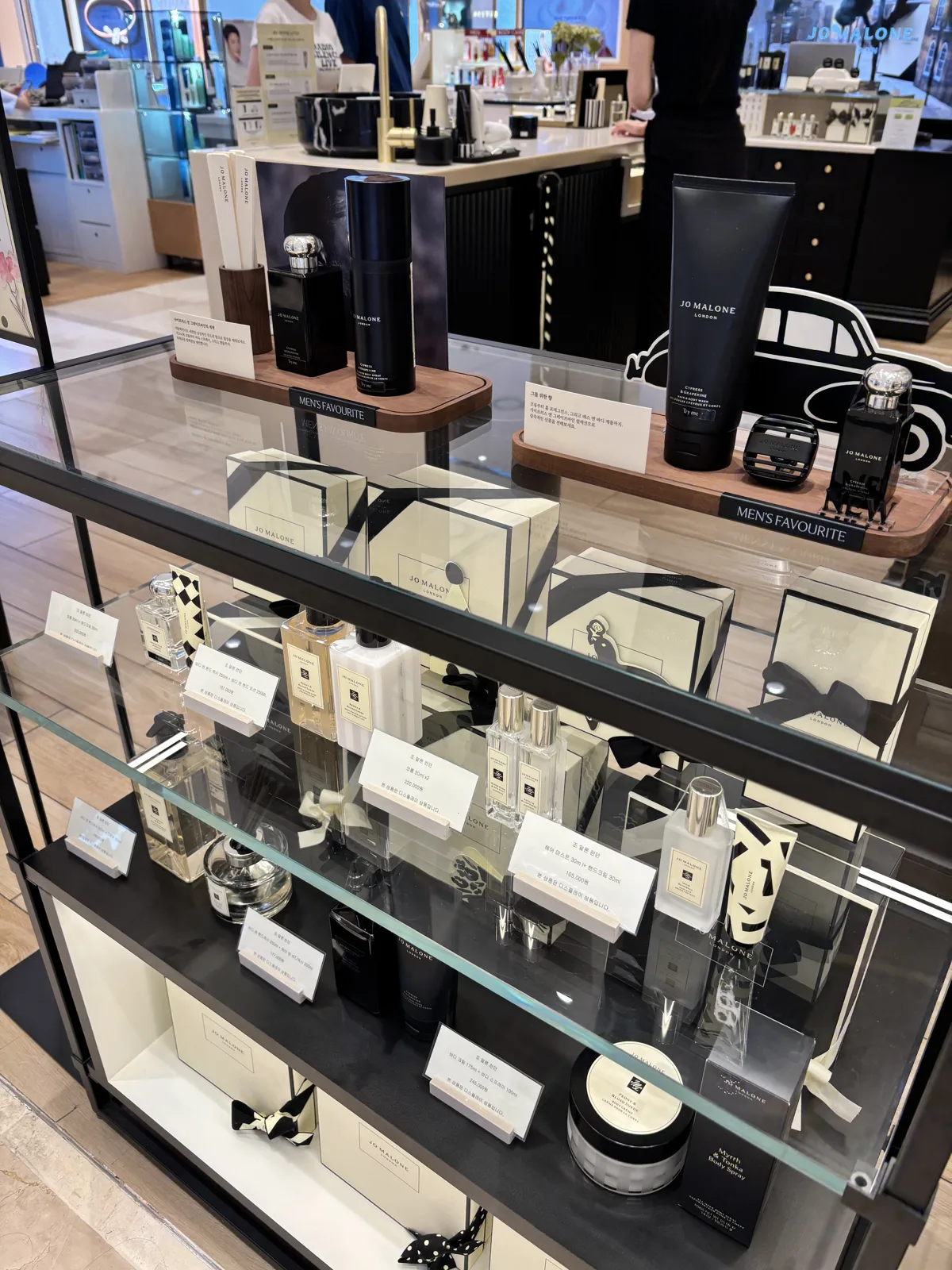 Arched, elegant Seoul department store beauty hall floor with fragrance and cosmetics counters