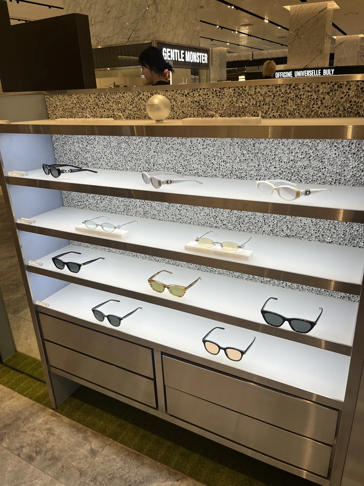 White marble skincare counter lined with products in a Seoul department store beauty hall