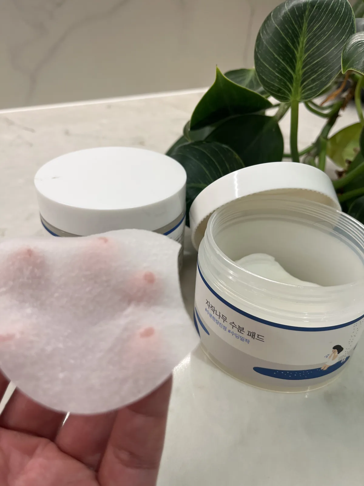 Korean toner pad jar opened showing textured essence-soaked pads — best Korean toner pads that actually work