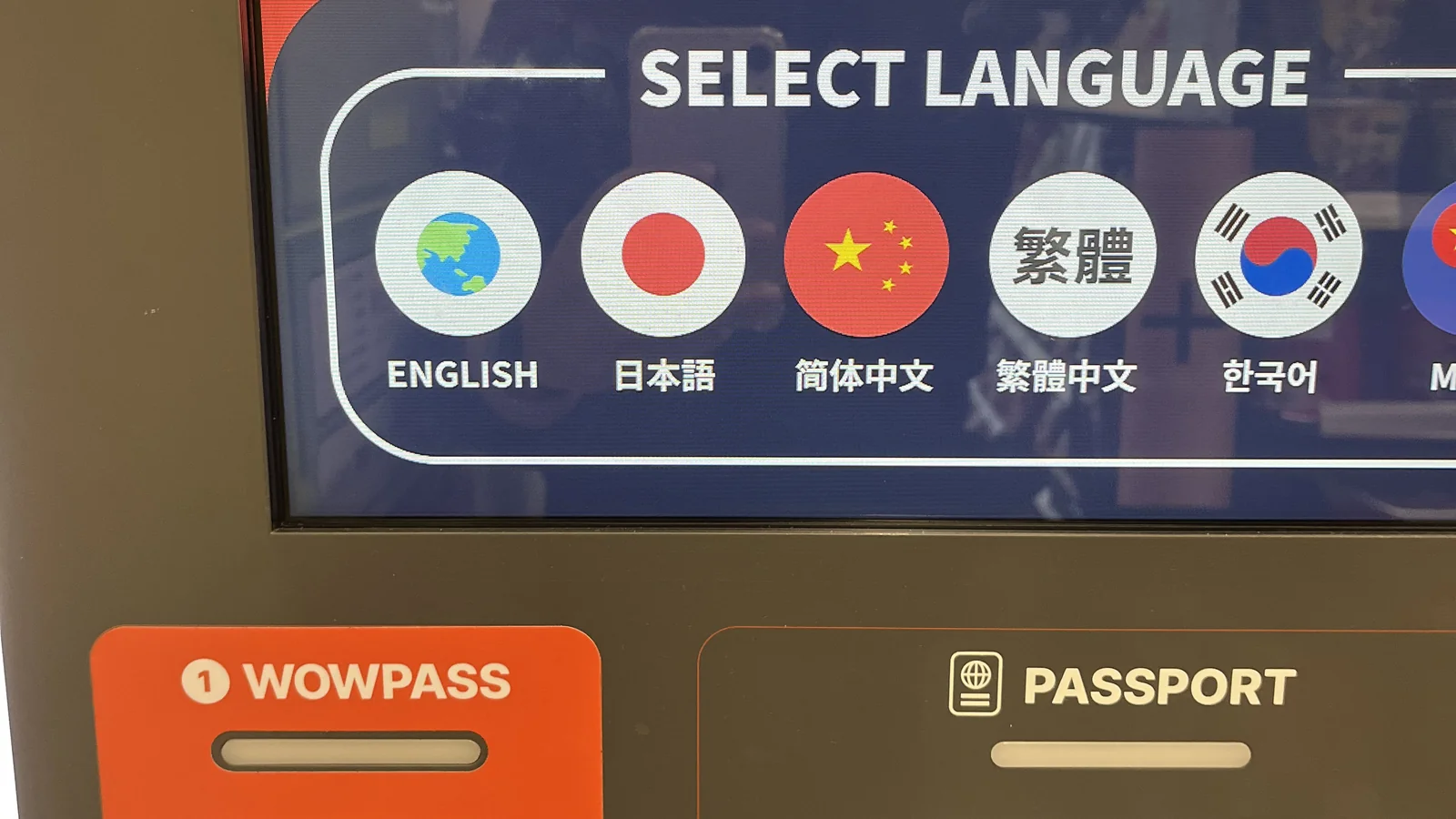 WOWPASS Korea kiosk language selection screen with the card and passport slots at Incheon Airport