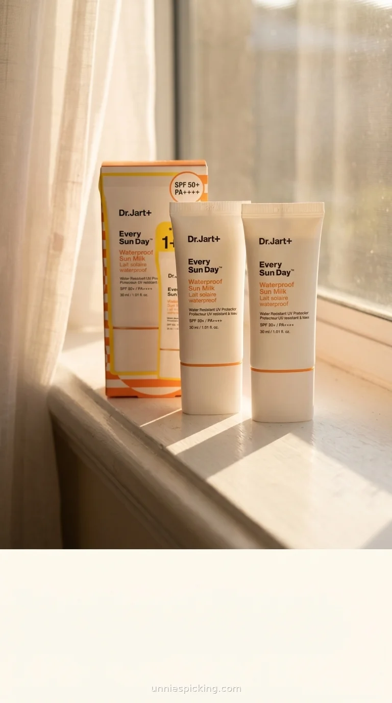 Dr.Jart Every Sun Day Sun Milk box and two tubes on a windowsill in golden light