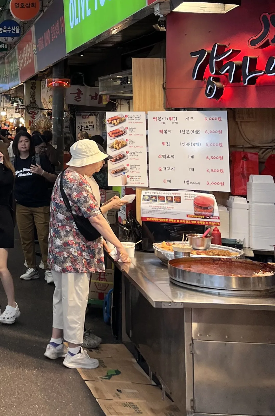 Street food menu board with real 2026 prices at a Gwangjang Market tteokbokki stall — planning a Korea travel budget