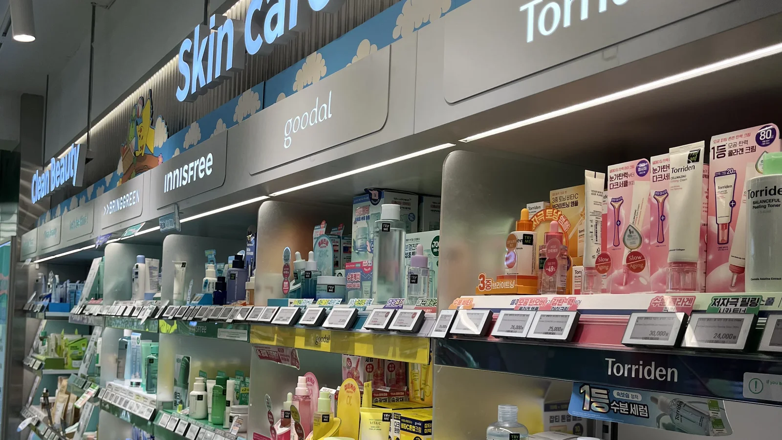 Skincare wall at Olive Young Gangnam with Torriden, innisfree and goodal shelves — the choice overload a free Korean skincare quiz solves