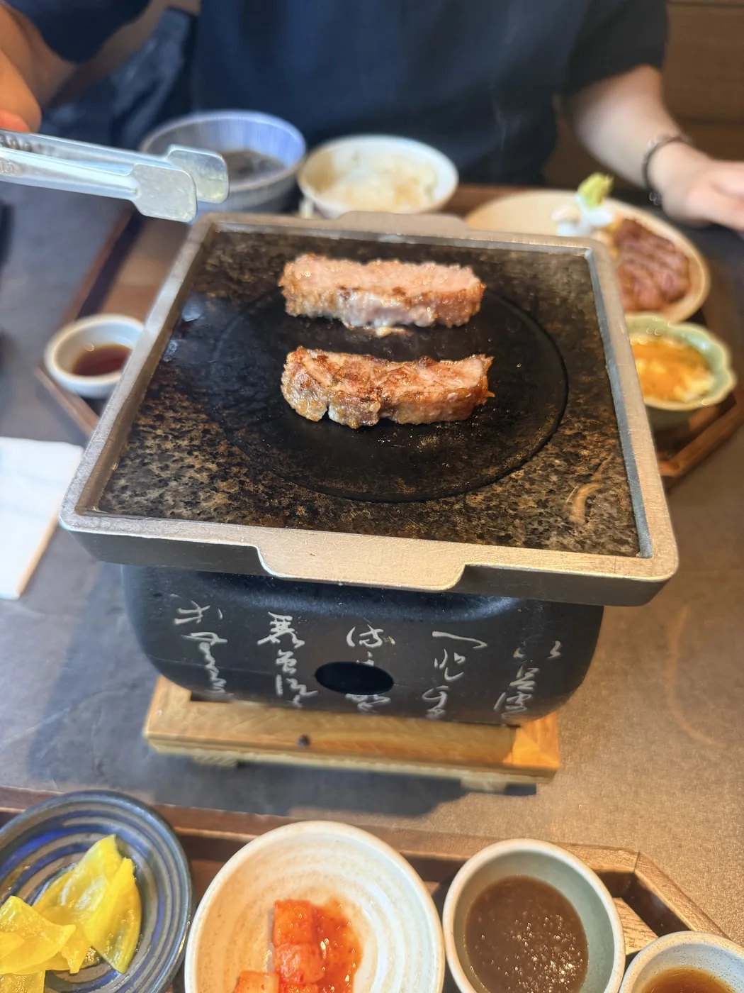 Seongsu-dong food guide Seoul: searing a gyukatsu beef cutlet on a hot stone at Sato Gyukatsu