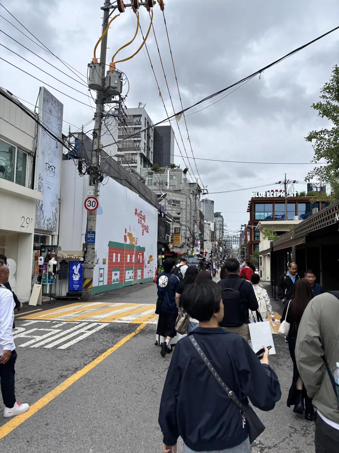 things to do in Seongsu-dong on a weekend: the busy main street filled with weekend crowds outside shops and cafes
