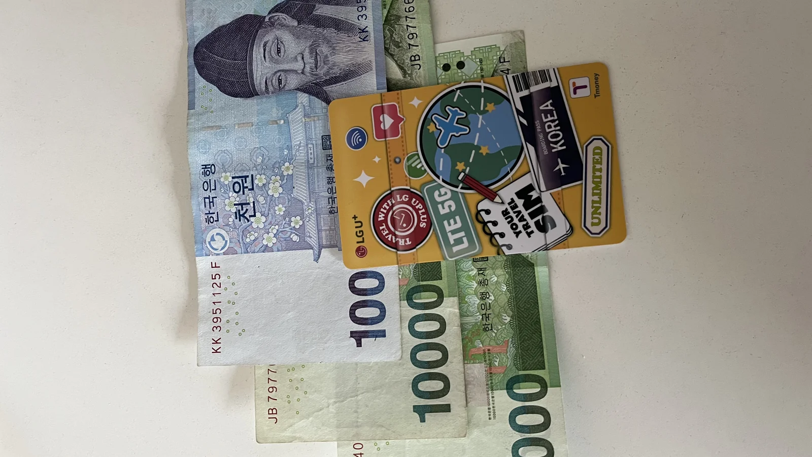 how to recharge t-money card in korea — Korean won cash bills next to a T-money card