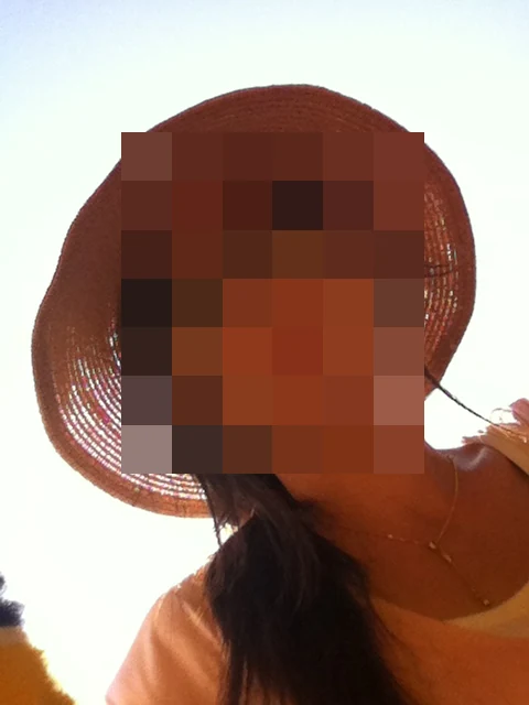 Unnie, the Seoul-born writer behind UnniesPicking, outdoors in Sydney in a wide-brimmed straw hat and sunglasses