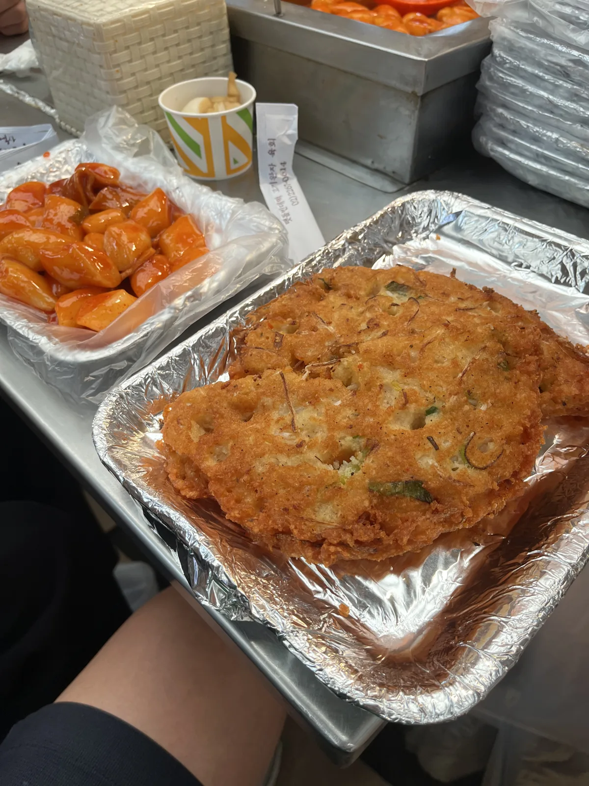 Tteokbokki Korean street food: tteokbokki and bindaetteok on a tray at Gwangjang Market Seoul