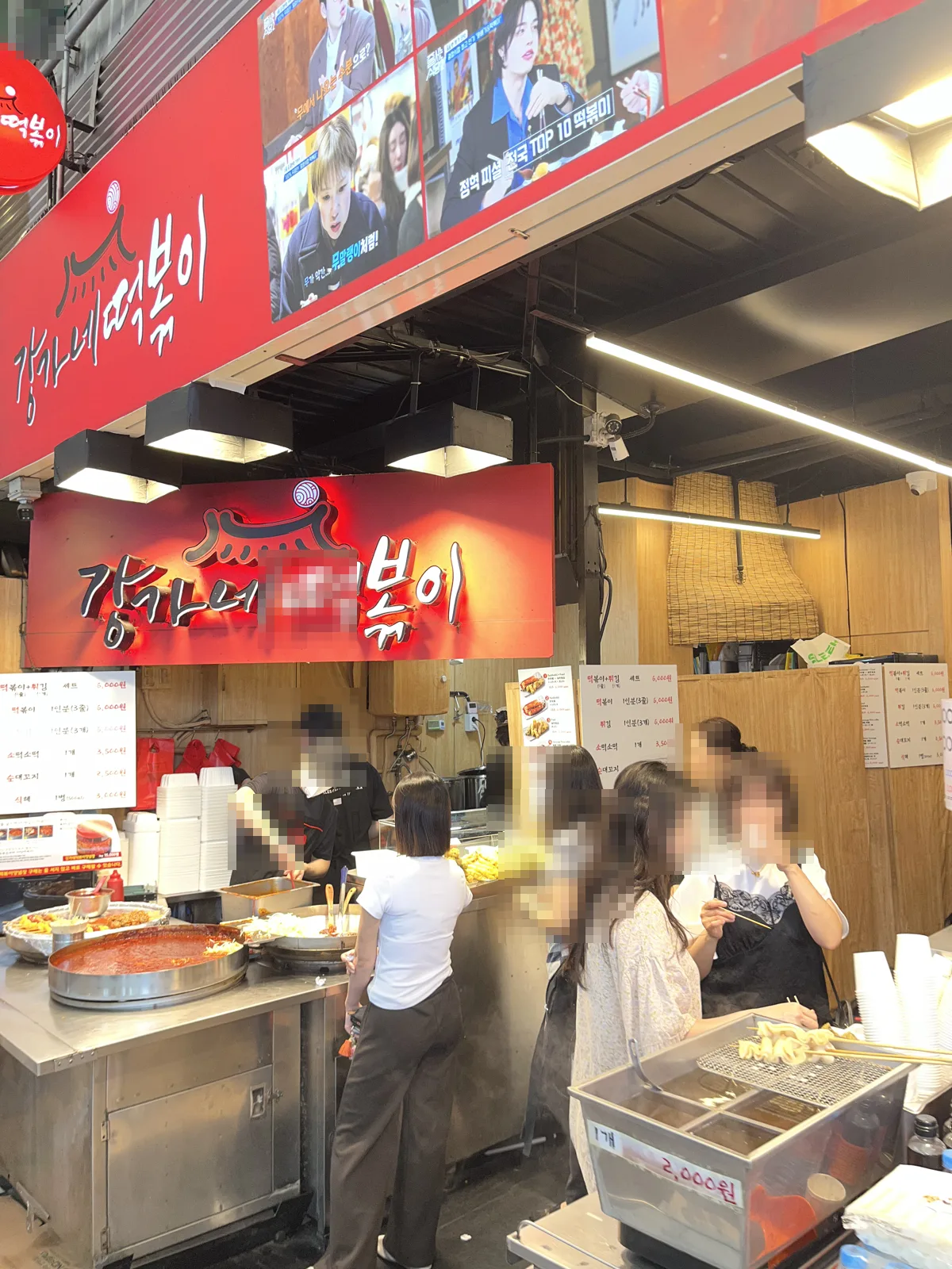 Tteokbokki Korean street food stall with red sign at Gwangjang Market Seoul